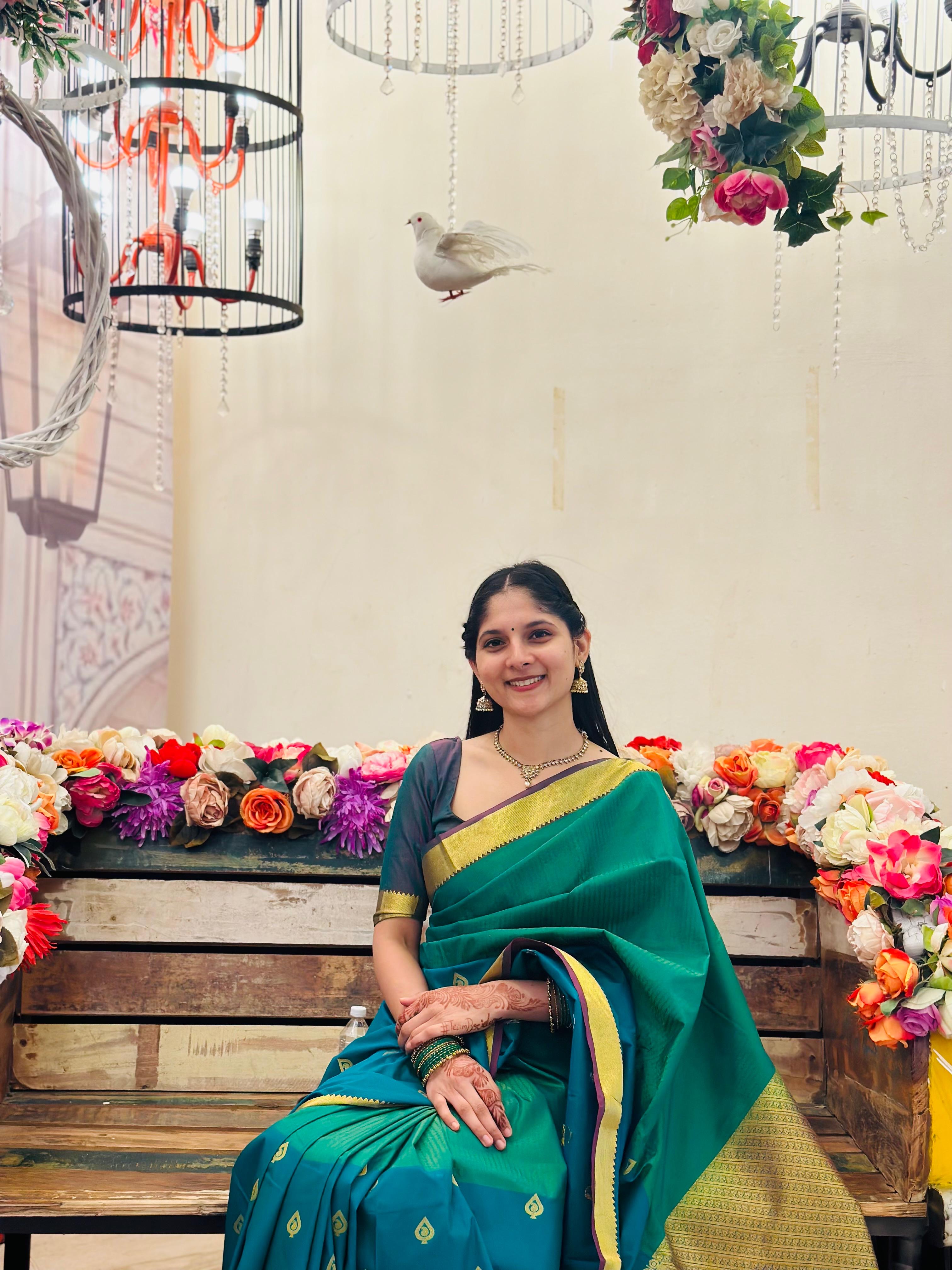 Green saree with floral backdrop