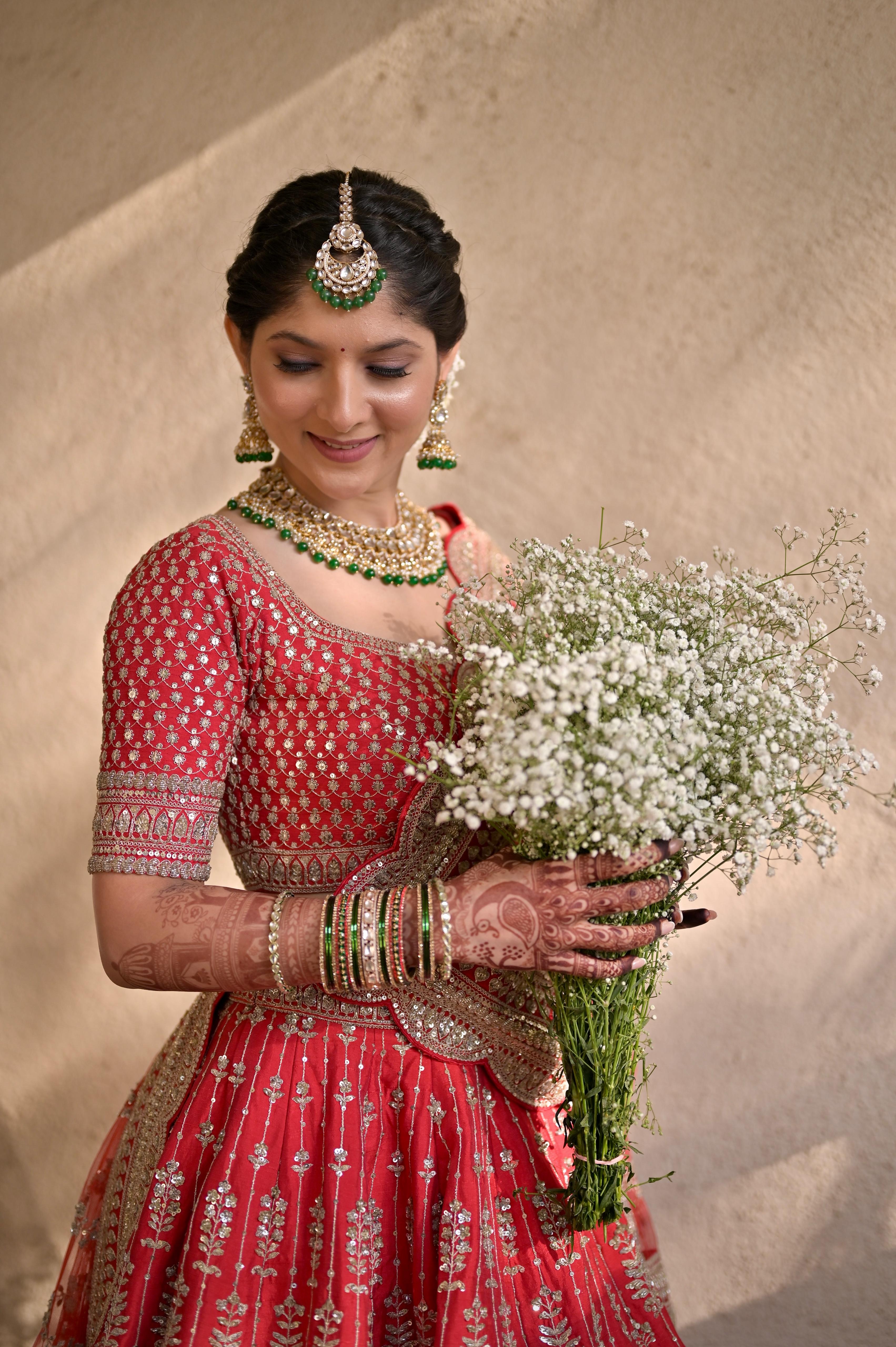 Red bridal outfit close-up with baby's breath bouquet