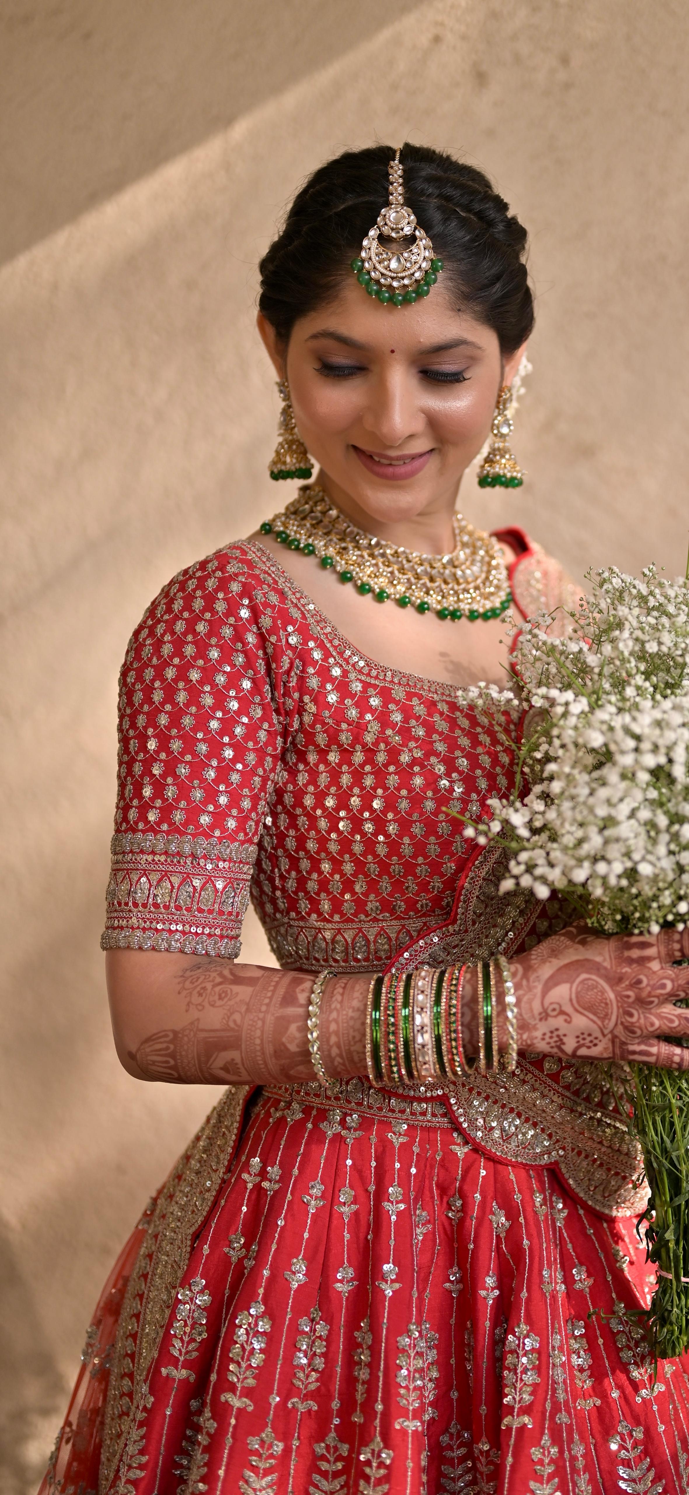 Red bridal close-up portrait with bouquet